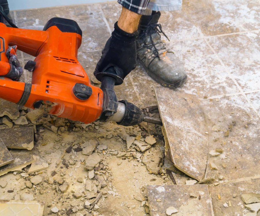 Preparation of repair the bathroom. Removing old tiles with jackhammer